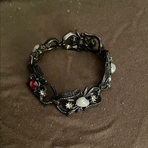 Elegant Black and Silver Bracelet with Red Accents